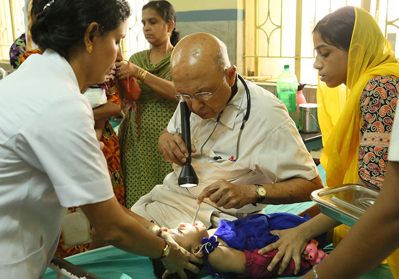 Dr. Adenwalla working with a patient