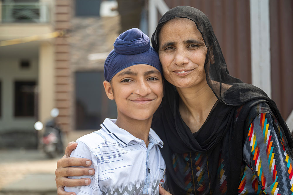 Anmolpreet smiling with his mother Tarsem after cleft surgery