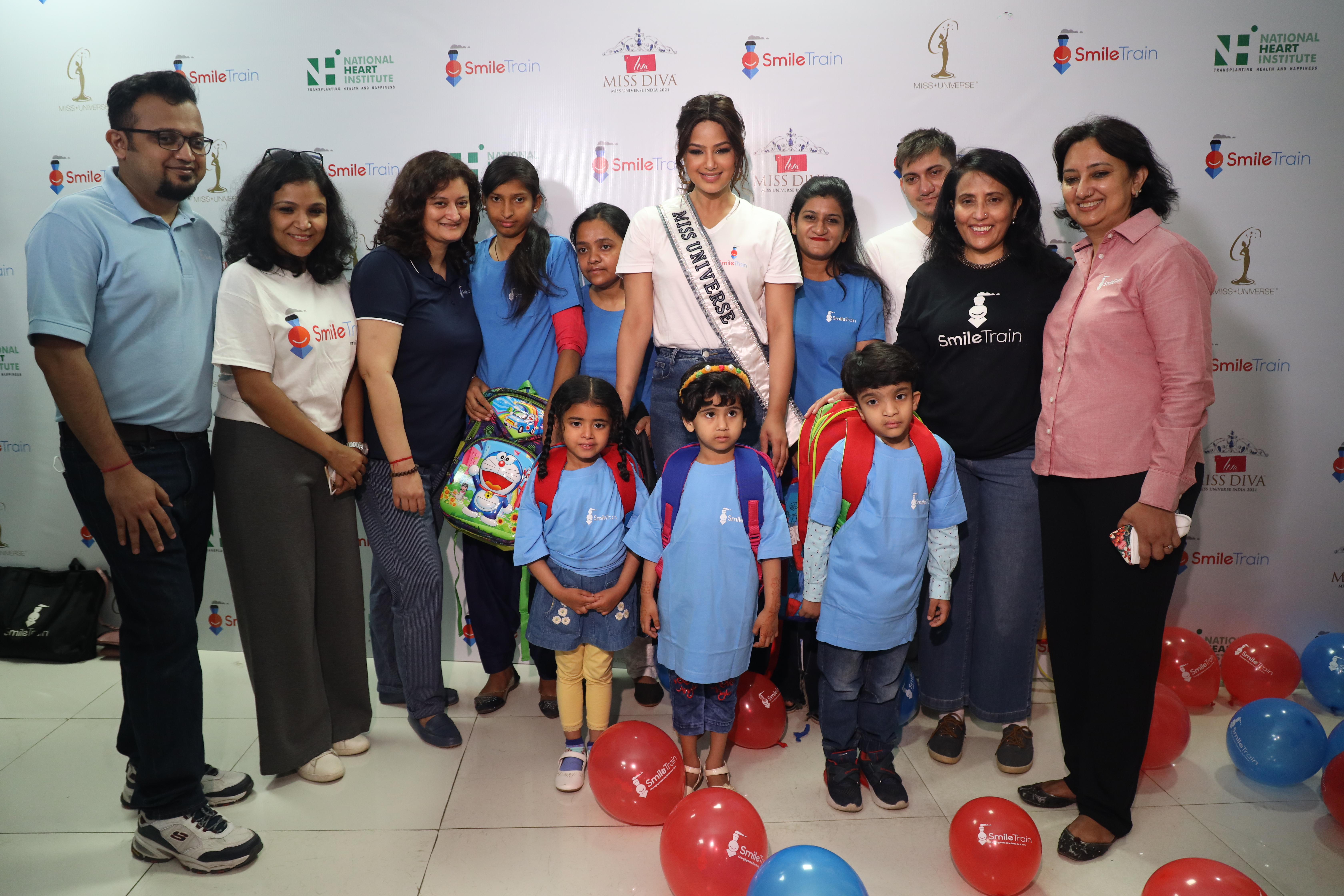 Harnaaz Sandhu smiling with patients and the Smile Train India team