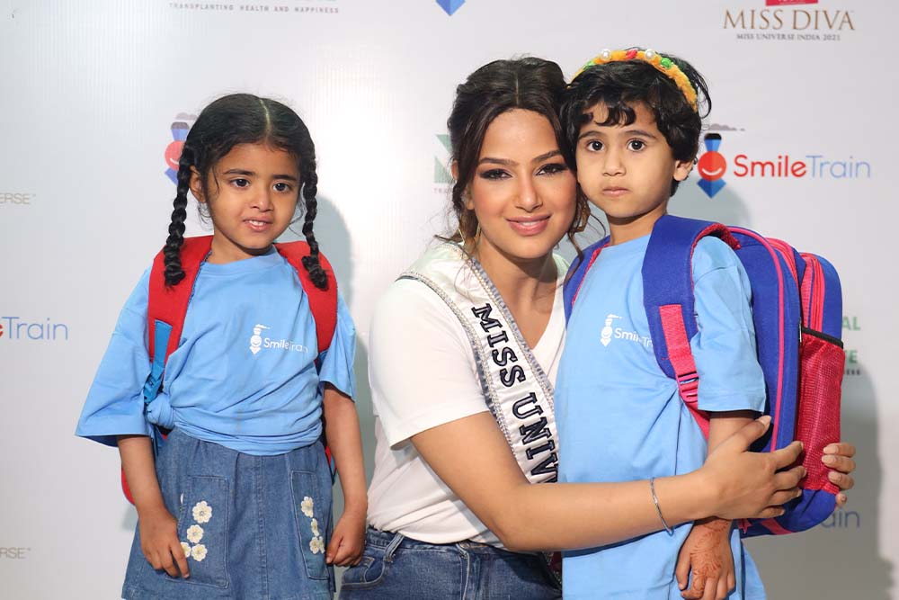 Harnaaz Sandhu smiling with two children