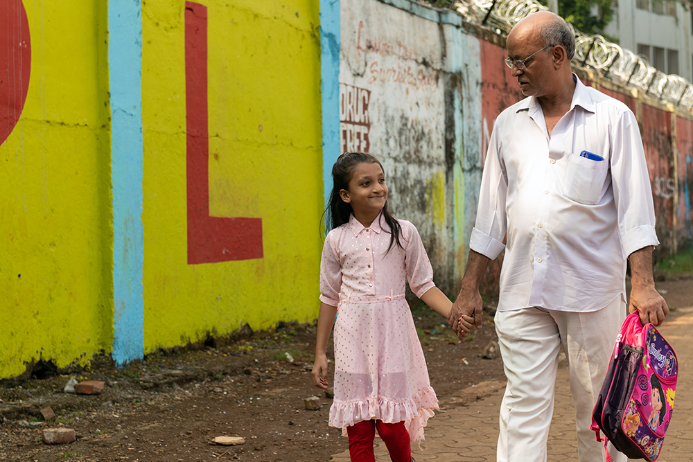 Humera smiling and walking with her grandfather