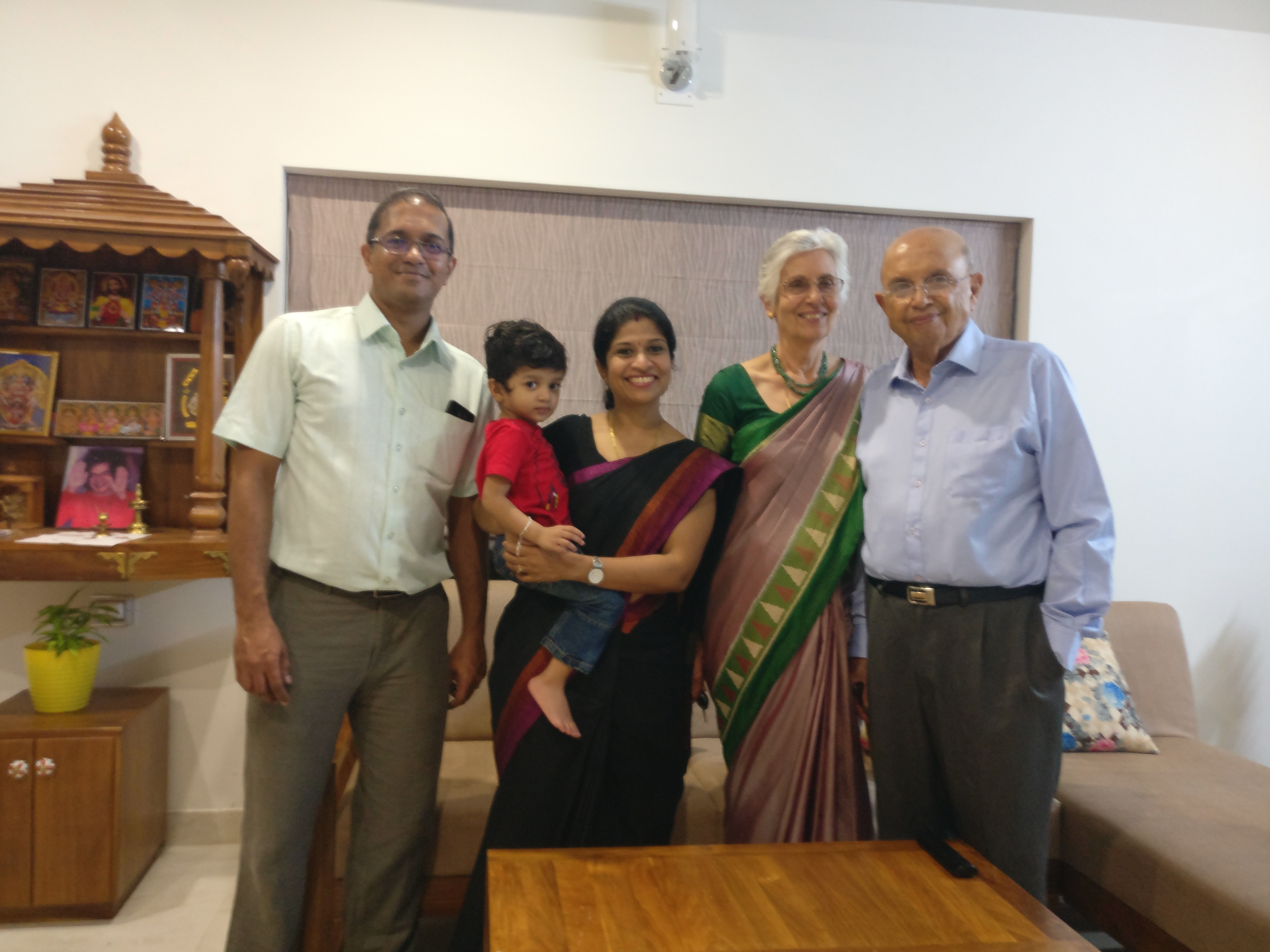 Dr Hirji Adenwalla smiling with a family