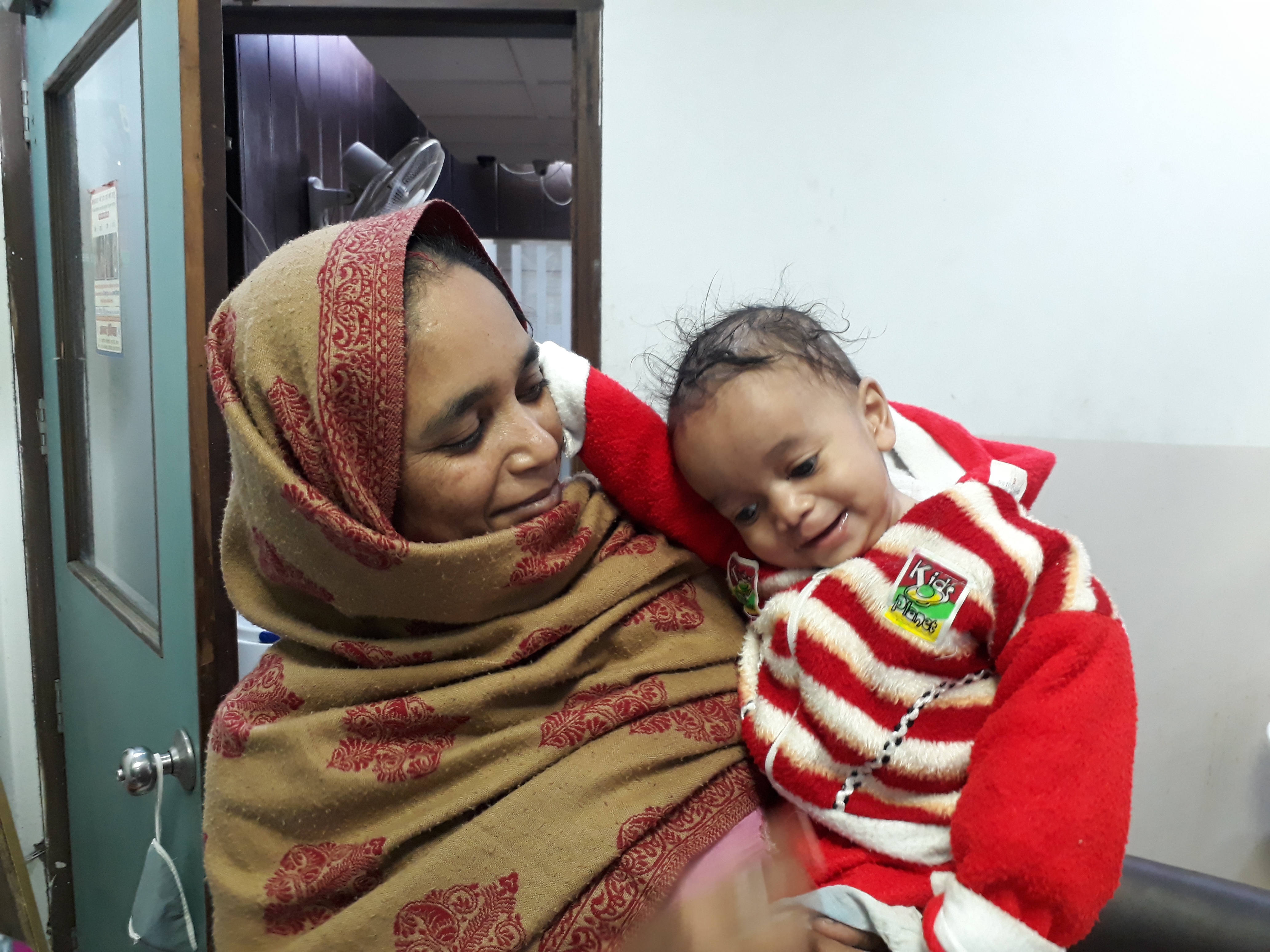 Aqib and his mother after cleft surgery