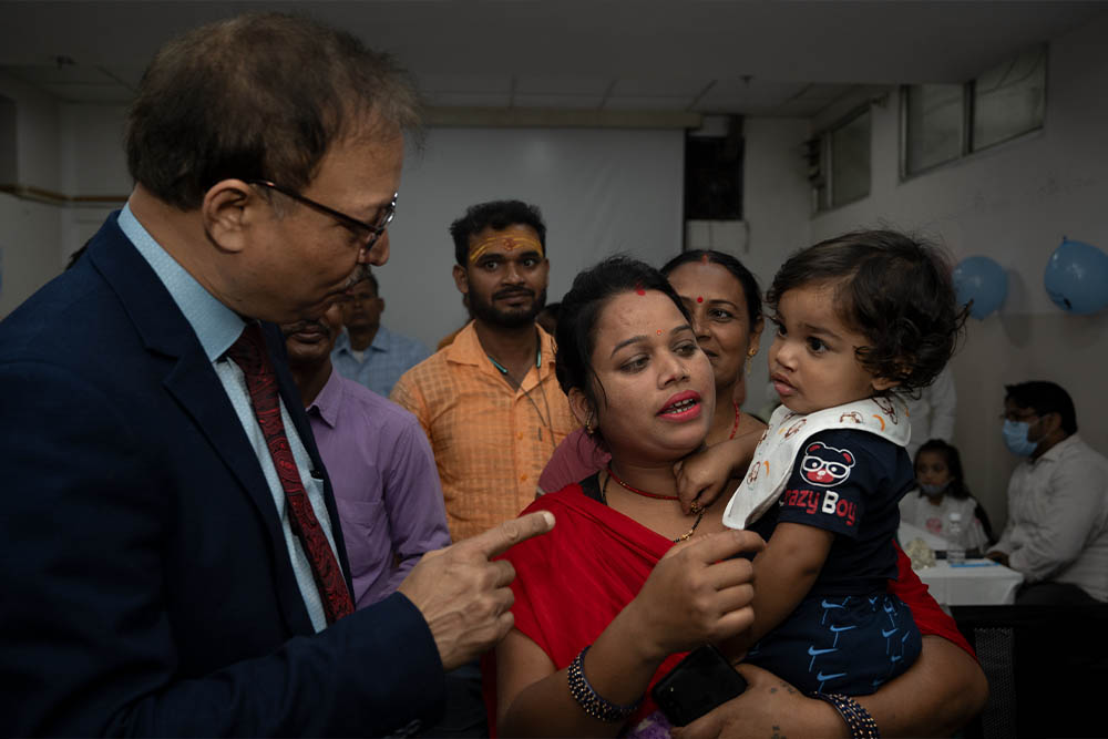 Dr Subodh talking to a cleft patient and their mother