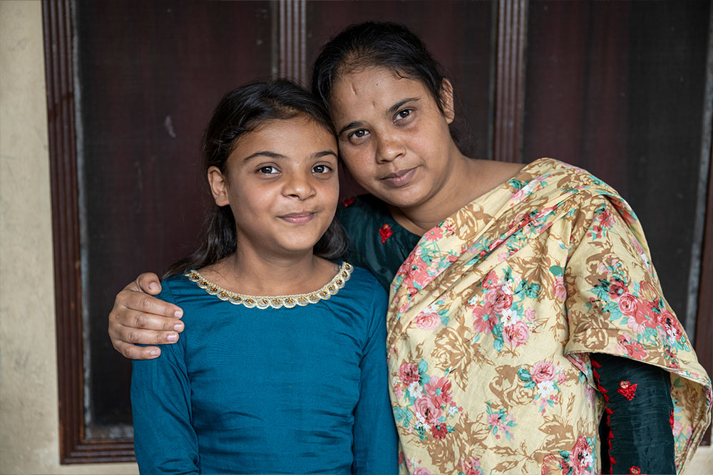 Paulwin smiling with her mother Rebecca after her cleft surgery