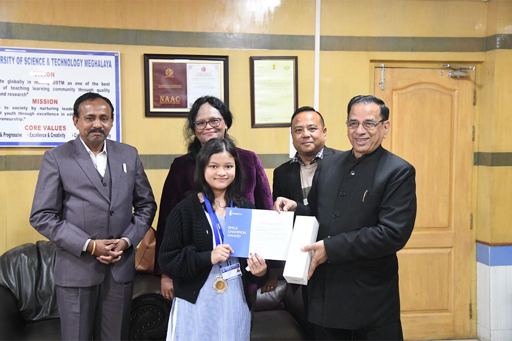 Student volunteer receiving a certificate at Meghalaya Smiles