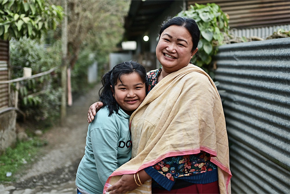 Bena smiling and hugging her mother Romila after cleft surgery