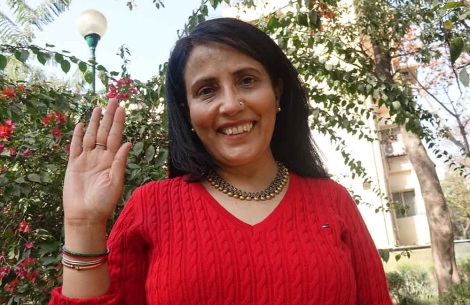 Mamta Carroll smiling and waving