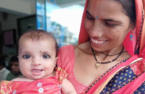 Sonali's mother holding her after her cleft surgery