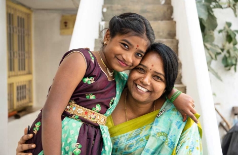 Akshara smiling and hugging her mother after cleft surgery