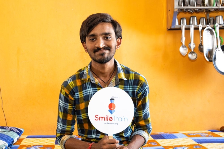 Sravan holds Smile Train sign