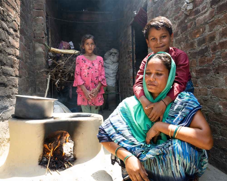 Shubham hugging his mother next to a fireplace after cleft surgery