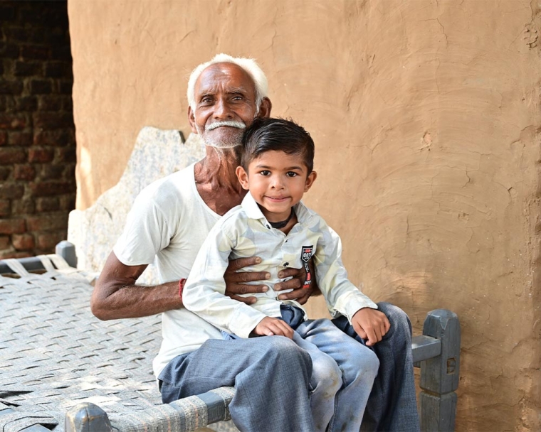 Jairaj smiling with his grandfather after cleft surgery