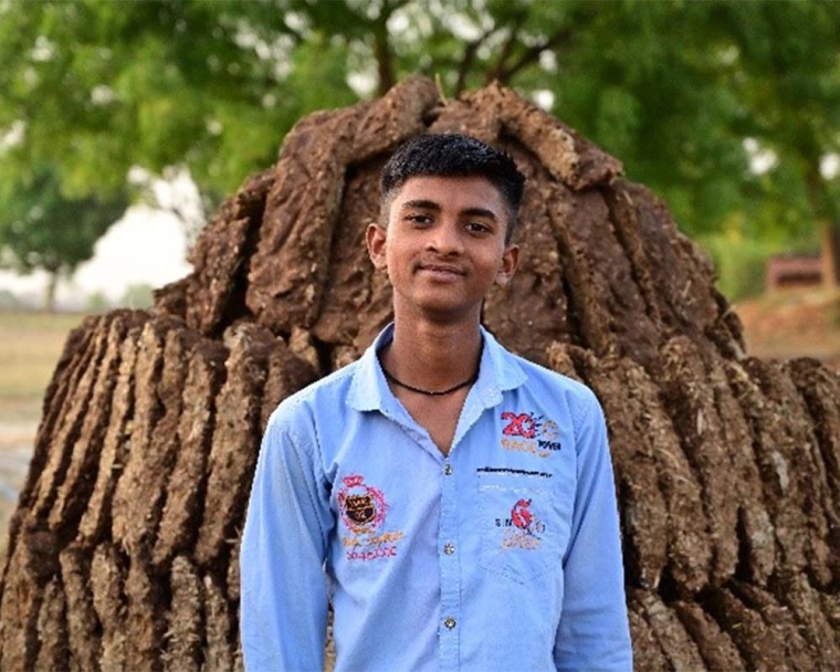Monu standing and smiling after cleft surgery